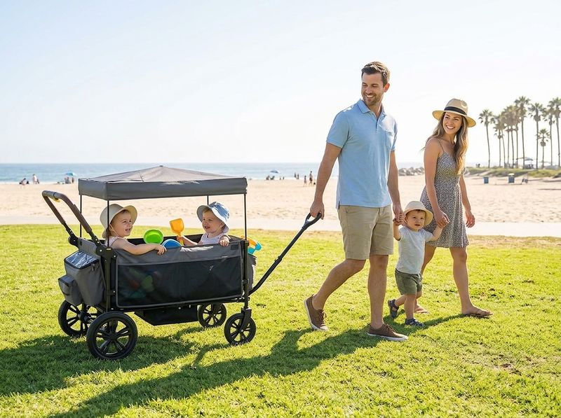 Parent pulling a loaded stroller wagon across beach sand